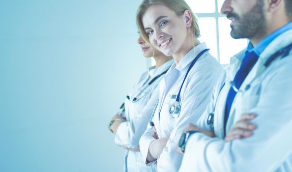 Portrait of confident doctors with arms crossed at medical office.