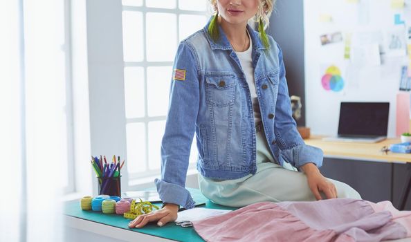 Fashion designer woman working on her designs in the studio.