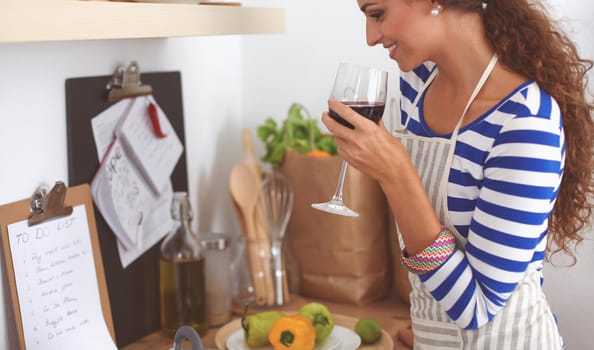 Attractive woman preparing food in the kitchen, standing