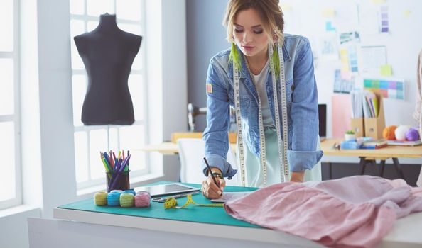 Fashion designer woman working on her designs in the studio.