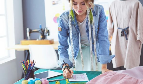 Fashion designer woman working on her designs in the studio.