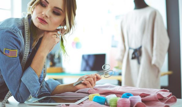 Fashion designer woman working on her designs in the studio.