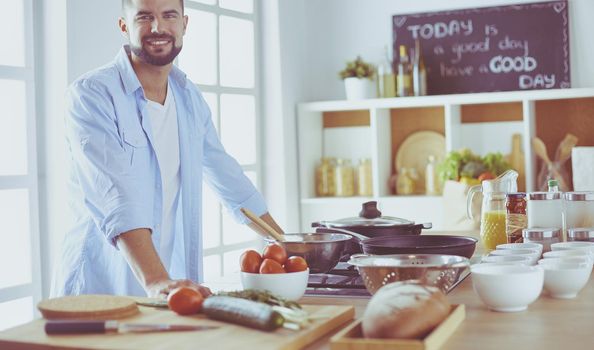 Man preparing delicious and healthy food in the home kitchen.