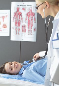 Doctor and patient discussing something while sitting at the table . Medicine and health care concept.