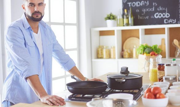 Man preparing delicious and healthy food in the home kitchen.