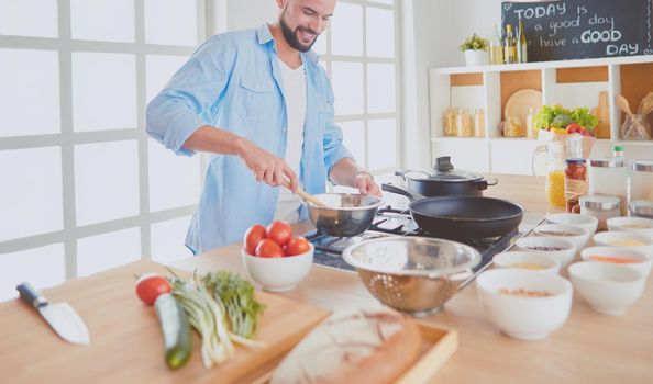 Man preparing delicious and healthy food in the home kitchen.
