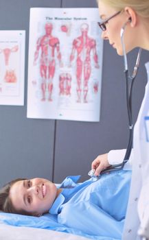 Doctor and patient discussing something while sitting at the table . Medicine and health care concept.