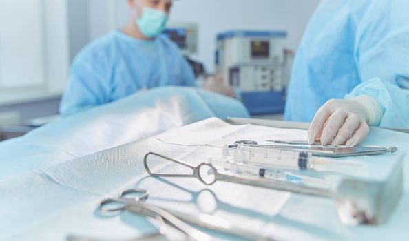 Team surgeon at work in operating room.