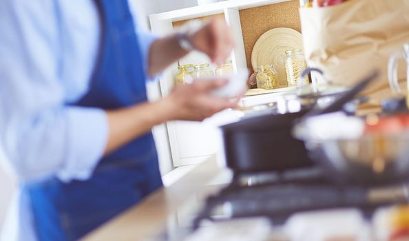 Man preparing delicious and healthy food in the home kitchen.