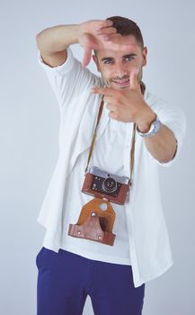 Young man with camera. Isolated over white background