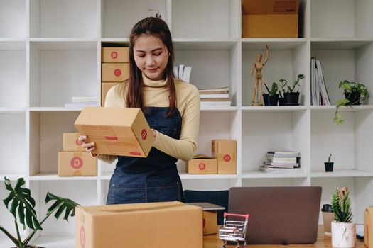 Young asian woman check order for shipping at home, business owner woman start up for business online, SME, Delivery project, woman with Online business or SME concept.