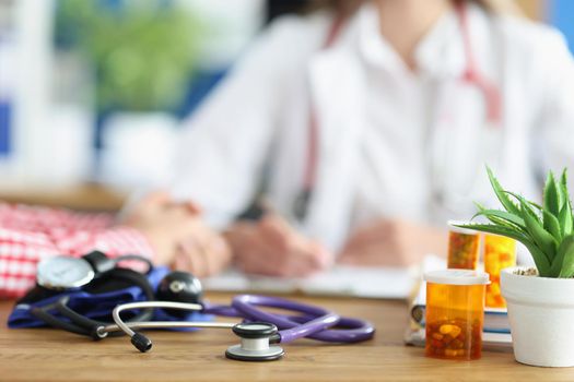 Close-up of doctor appointment in clinic, medical equipment stethoscope and medication. Health checkup, planned visit. Medicine, clinic, healthcare concept