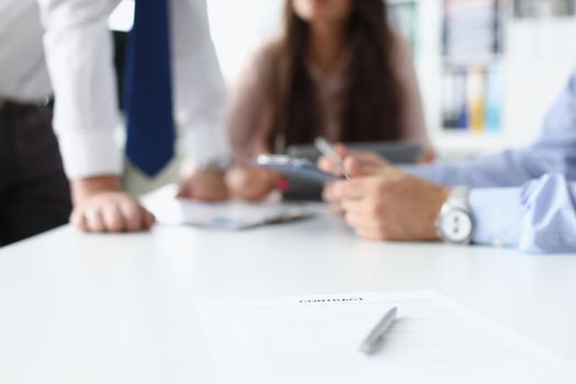 Close-up of businesspeople having meeting in conference room, contract paper with pen on desk. Prepared business document for client. Success, deal concept