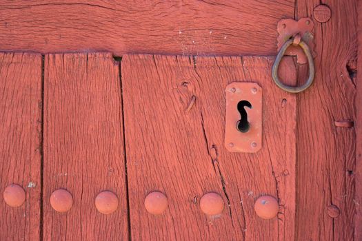 Closeup of vintage lock and doorknocker, wooden door