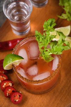 Michelada the Mexican Bloody Mary. Made with tequila, spicy sauce, served over ice in a glass of celery with a peppery rim, garnished with a stalk of celery and a wedge of lime. Drinks and cocktails with hot sauce, add some spice to your life