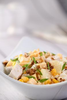 Chicken salad with pineapple, corn and cucumber dressed with Greek yogurt, crushed nuts and cheese.