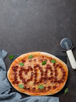 Father's day background. Pepperoni pizza with i love dad lettering on black tabletop. Father day concept, recipe and idea. Top view or flat-lay. Copy space for text. Vertical.