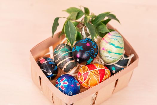 Easter basket with painted eggs. Easter holiday tradition. Easter Egg Hunt. Colorful easter eggs. Spring religious holiday