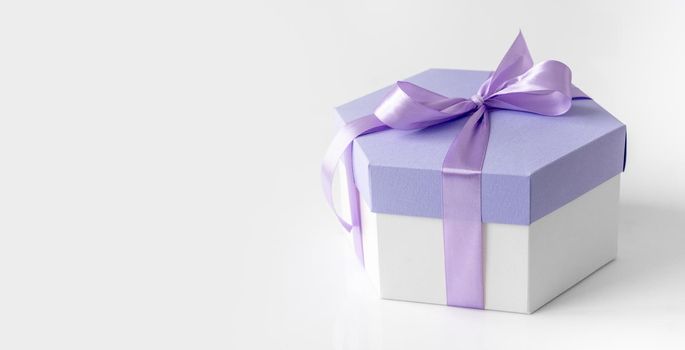 Beautiful gift box with lavander ribbon for celebration. Romantic present package for Valentine day and anniversary