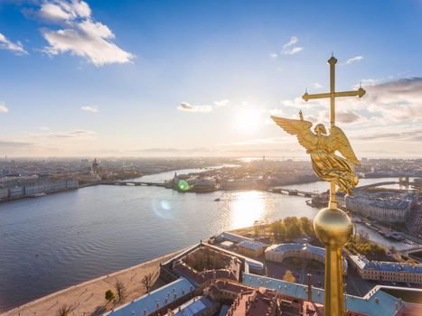 Russia, St. Petersburg, Aerial landscape of Peter and Paul cathedral at sunset, walls of fortress, Golden autumn, panorama landscape, golden spire with cross and angel, drawbridges, river Neva. High quality photo