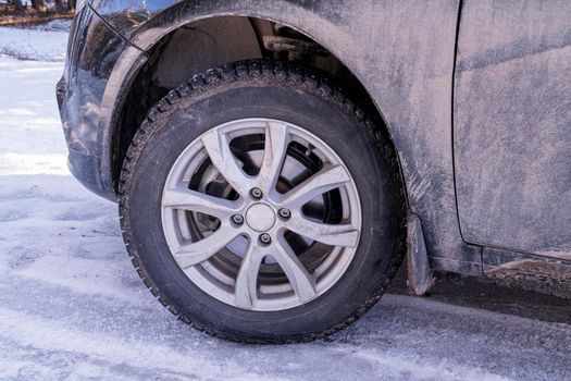 a car wheel with spikes in the snow. High quality photo