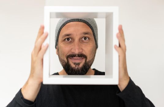 Happy adult man with frame. High quality photo