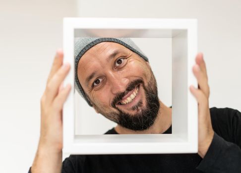 Happy adult man with frame. High quality photo