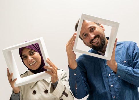 Pretty woman and man with a frame. High quality photo