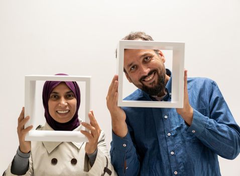 Pretty woman and man with a frame. High quality photo