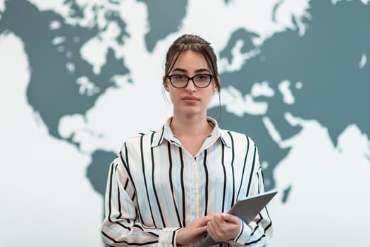 Portrait of businesswoman in casual clothes holding tablet computer at modern startup open plan office interior. Selective focus. High-quality photo