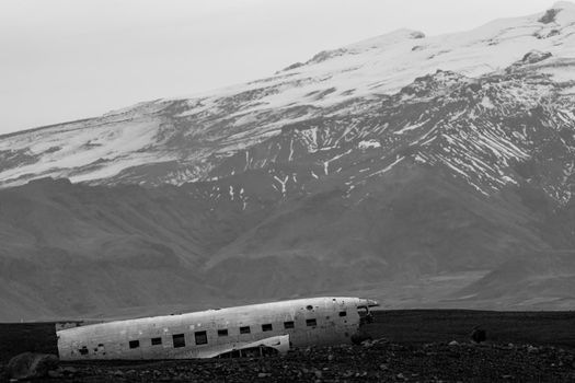 Wreck of and airplane profile and mountains in the background