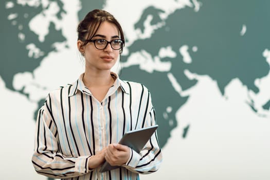 Portrait of businesswoman in casual clothes holding tablet computer at modern startup open plan office interior. Selective focus. High-quality photo