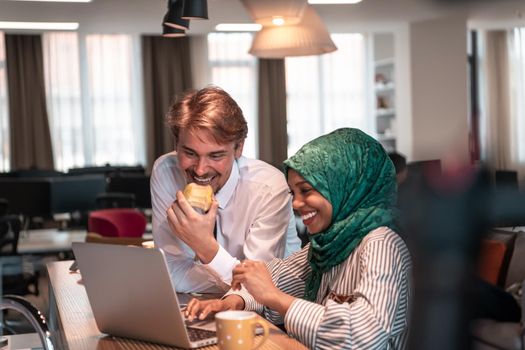 International multicultural business team. A young businessman and businesswoman sit in a modern relaxation space and talk about a new business. High-quality photo