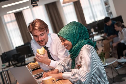 International multicultural business team. A young businessman and businesswoman sit in a modern relaxation space and talk about a new business. High-quality photo