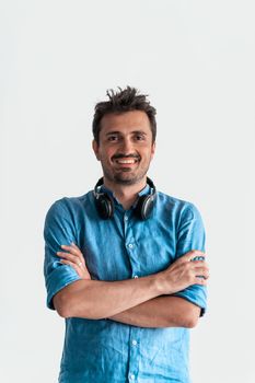 Formal business male portrait. A confident successful casual businessman or manager stands in front of a white background, arms crossed, looking directly at the camera and smiling friendly. High-quality photography.