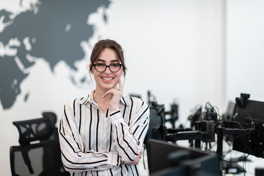 Portrait of businesswoman in casual clothes with glasses at modern startup open plan office interior. Selective focus. High-quality photo