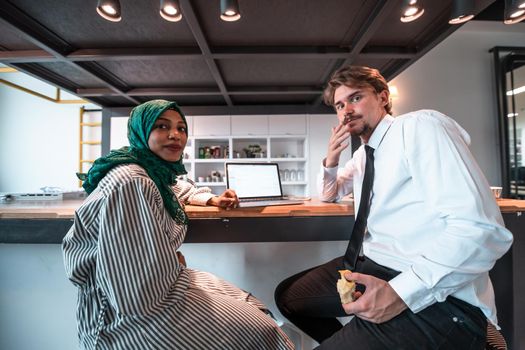 International multicultural business team. A young businessman and businesswoman sit in a modern relaxation space and talk about a new business. High-quality photo