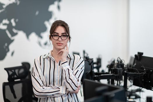 Portrait of businesswoman in casual clothes with glasses at modern startup open plan office interior. Selective focus. High-quality photo