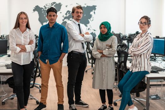 Portrait of young excited multiethnics business team of software developers standing and looking at the camera at modern startup office. High-quality photo