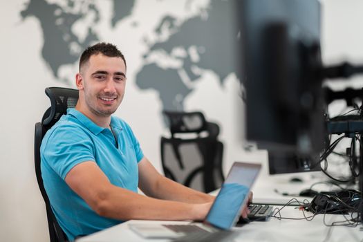 A time to relax. Young tired casual businessman relaxing at the desk in his office. Selective photo. High-quality photo