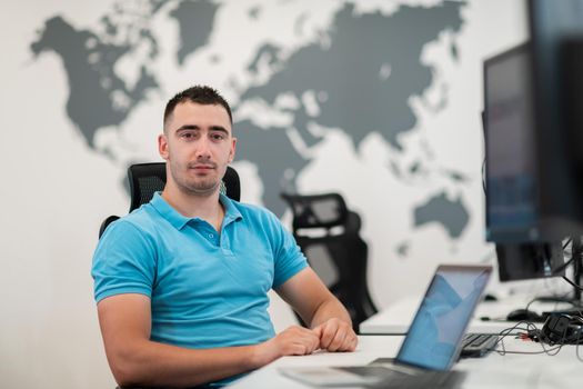 A time to relax. Young tired casual businessman relaxing at the desk in his office. Selective photo. High-quality photo