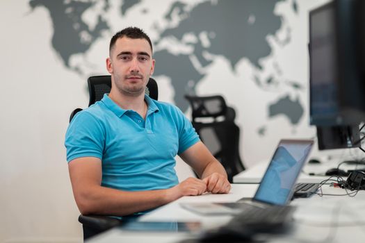 A time to relax. Young tired casual businessman relaxing at the desk in his office. Selective photo. High-quality photo