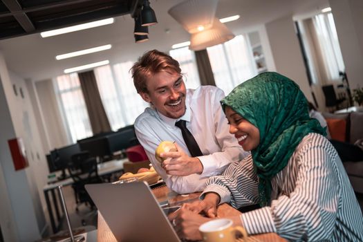 International multicultural business team. A young businessman and businesswoman sit in a modern relaxation space and talk about a new business. High-quality photo