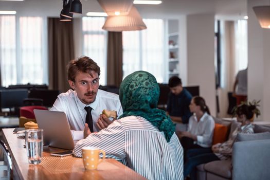 International multicultural business team. A young businessman and businesswoman sit in a modern relaxation space and talk about a new business. High-quality photo