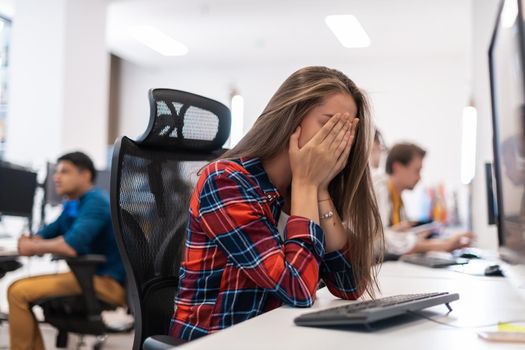 Beautiful Shocked and Annoyed Young Woman Looking at her desktop. Sad Operator Agent Woman Working from Home in a Call Center. High-quality photo