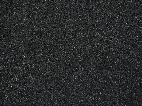 Black rough backdrop. Smooth asphalt road. Tarmac texture. Top view. Stucco surface. Dark abstract pattern.