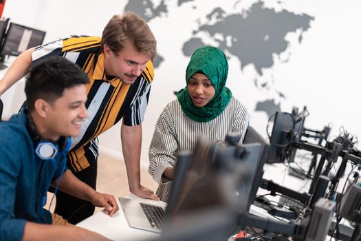 Multiethnic startup business team Arabian woman wearing a hijab on meeting in modern open plan office interior brainstorming, working on laptop and desktop computer. Selective focus. High-quality photo