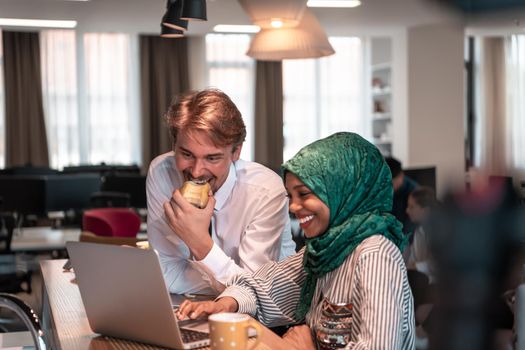 International multicultural business team. A young businessman and businesswoman sit in a modern relaxation space and talk about a new business. High-quality photo