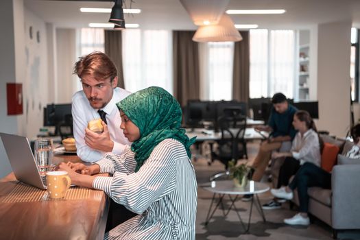 International multicultural business team. A young businessman and businesswoman sit in a modern relaxation space and talk about a new business. High-quality photo