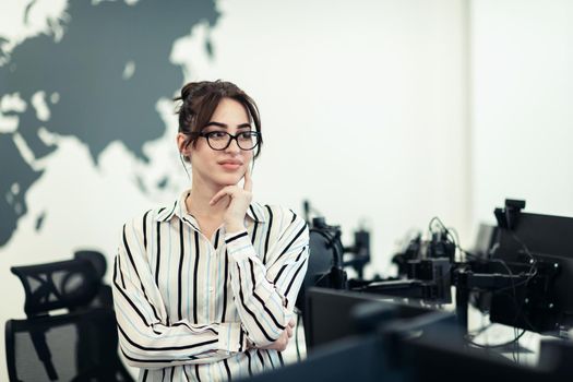 Portrait of businesswoman in casual clothes with glasses at modern startup open plan office interior. Selective focus. High-quality photo